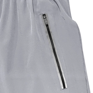Detail view of the gray functional shorts featuring a high-quality zipper pocket and fabric texture