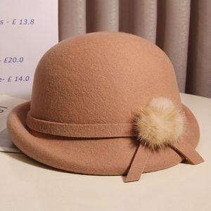 Detail of camel wool felt cloche hat with rabbit fur pompom and side ribbon bow