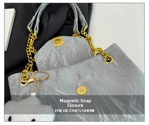 Detail of silver sequin bag with golden chain, magnetic closure and plush cloud charm