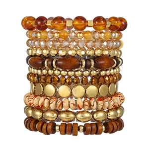 Bohemian multi-layer stacked bead bracelet set with brown, gold and amber tones on white