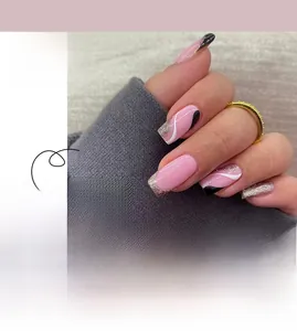Detailed view of pink ballerina press-on nails with black French tips and gold glitter lines
