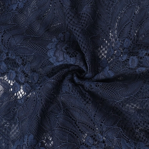 Close-up of dark blue lace fabric featuring intricate floral embroidery and mesh details
