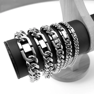 Macro shot of silver stainless steel Cuban link bracelets with rectangular metal plaques