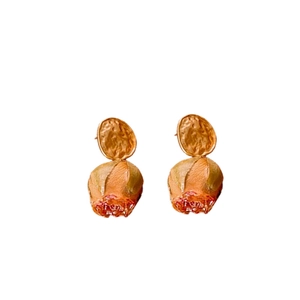 Vintage gold hammered stud earrings with orange rose bud pendants on white backdrop