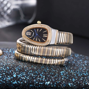 Macro shot of snake-shaped watch face with crystal bezel and blue leaf-shaped hands