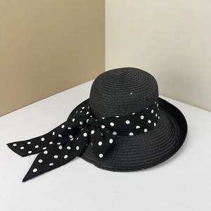 French style polka dot bow straw sun hat for women featuring a wide brim and elegant weave