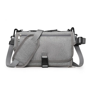 Detail of adjustable padded shoulder strap and buckle on grey quilted diaper organizer