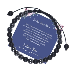 Detail of Morse code beaded bracelet on Mother's Day gift card with black frosted stones