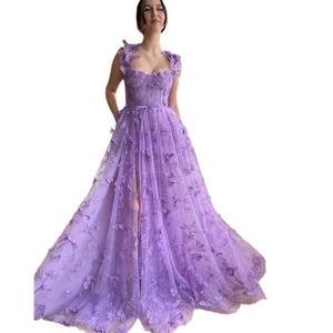 Detail of purple tulle dress showing 3D butterfly appliqués and sweetheart neckline