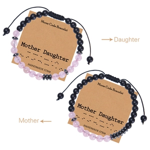 Detail of Morse Code mother daughter bracelets with pink beads and black woven cords