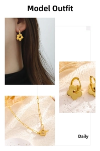 Detail of gold flower jewelry set with OT buckle necklace and earrings on stone background