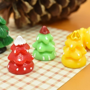 Miniature resin Christmas tree ornaments in red and green for DIY craft projects