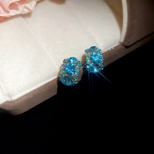 Detail of 18k gold plated hoop earrings with blue crystal pavé in a gift box
