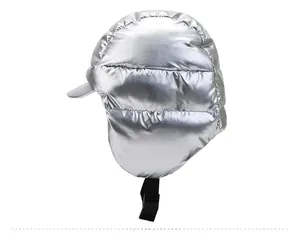 Detail showing the silver glossy fabric and adjustable buckle of the winter earflap hat