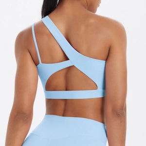 Light blue sports bra with asymmetrical back design and cutout detail in high stretch fabric