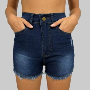 Close-up of high-waisted denim shorts featuring distressed wash and frayed tassel hem