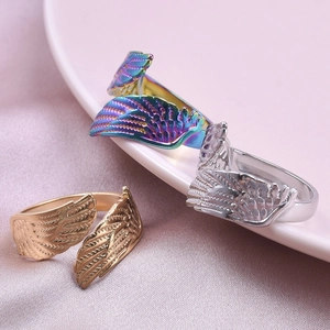Adjustable stainless steel wing rings in gold, silver, and rainbow colors on satin cloth