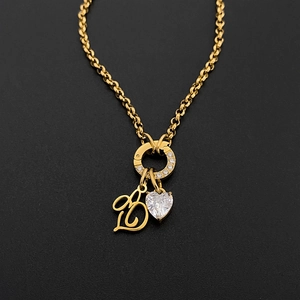 Close-up of titanium steel necklace with artistic letter B and heart-shaped diamond