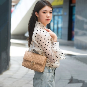 Fashionable beige quilted shoulder bag with golden chain strap for women in summer style