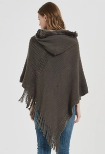 Back view of a hooded brown-gray knit poncho with fur trim and fringe tassels
