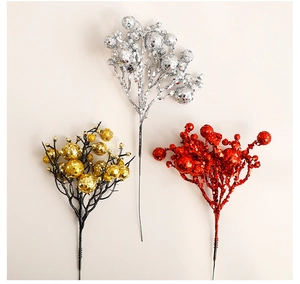 Close-up of artificial Christmas berry picks in red, gold, and silver with glitter finish