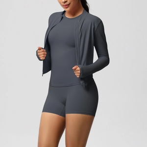 Detail view of the high-stretch seamless fabric on dark gray 3-piece women's yoga set