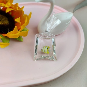 Detailed view of goldfish water bag pendant with yellow tropical fish in resin material