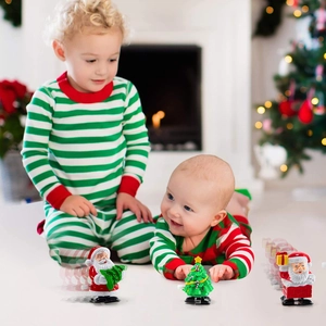 Kids playing with Christmas wind-up Santa and reindeer toys in a festive living room