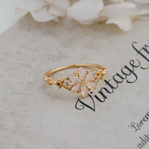 Detailed macro view of a vintage floral S925 silver ring with faux opal and gold plating