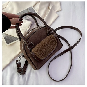 Detail view of plush patchwork brown handbag with velvet texture and silver hardware