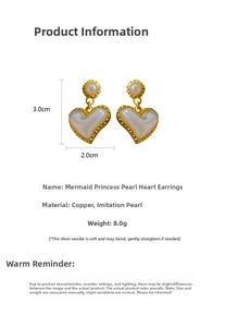 Macro shot of iridescent heart pearl earrings with golden wavy edges and silver pins