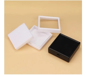 Detail view of square acrylic jewelry boxes with black and white foam inserts