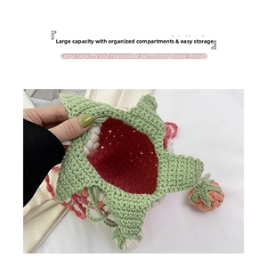Macro shot of handmade crochet strawberry bucket bag showing vibrant red inner lining