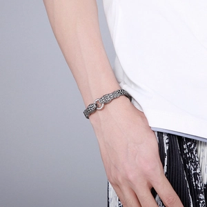 Detail shot of men's stainless steel snake head bracelet with scaled texture on wrist