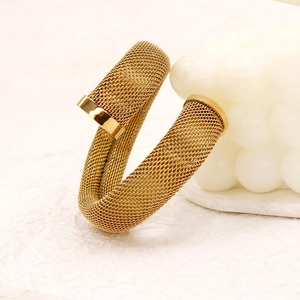 Macro detail of golden mesh braided stainless steel bracelet with polished end caps