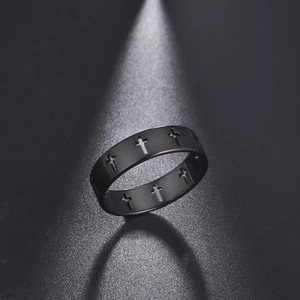 Macro shot of wide black matte stainless steel ring with hollowed cross pattern cutouts