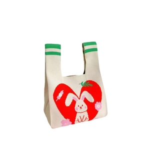 Knitted tote bag in beige with red heart and white rabbit pattern plus green handles