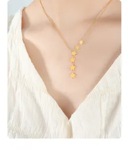 Close-up of a gold star tassel Y-necklace featuring six stars on a minimalist chain