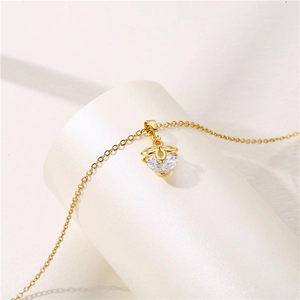 Golden stainless steel four-leaf clover necklace with sparkling zircon stone on white stand