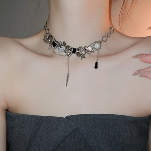 Close-up of silver punk choker with heart, star, flower, pearl and spike pendants