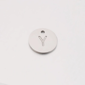 Close-up of a 12mm mirror polished stainless steel round charm with engraved letter Y