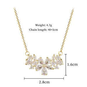Detail showing hollow zircon flower pendant size 2.8cm by 1.6cm on gold chain necklace