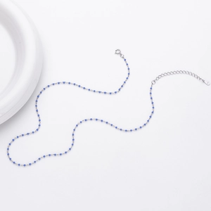 Detail view of S925 sterling silver chain featuring delicate blue beads and spring clasp