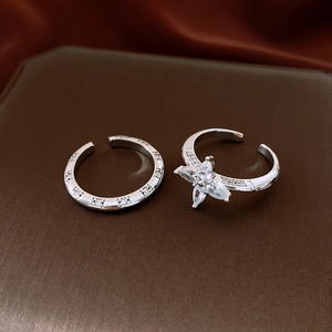 Macro view of silver adjustable rings featuring zircon flowers and pavé eternity band