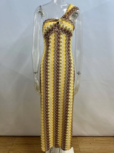 Close-up of one-shoulder knit dress with wavy chevron patterns in yellow and brown