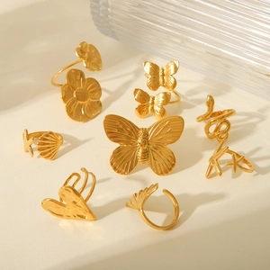 Golden stainless steel rings set featuring butterfly, heart, and floral designs for women