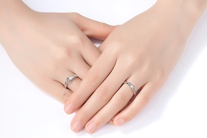 Close-up of couple crown rings with cubic zirconia on hands for wedding or engagement