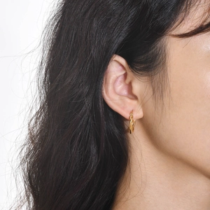 Minimalist twisted gold hoop earrings for women showing polished texture and elegant design