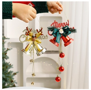 Detail of red and gold Christmas bell ornaments with ribbons for festive tree decoration