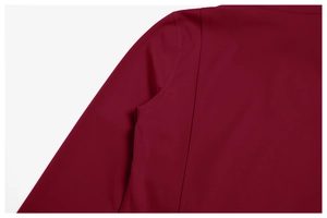 Close-up of flatlock seams and stretch fabric on burgundy fitness sportswear top